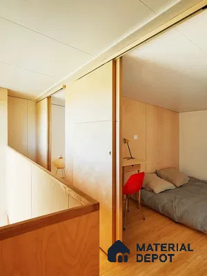 A bathroom with a large tub in the middle of it and wooden flooring next to a white tiled walls and white bathtub in front of a window with lots of a wooden table next to a large window
